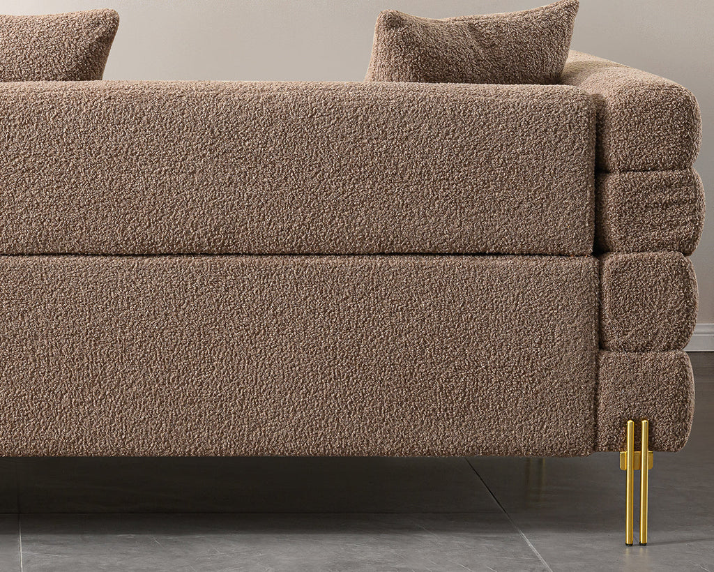 Luxurious and comfortable upholstered sofa with golden legs and pillows for living room and reception area