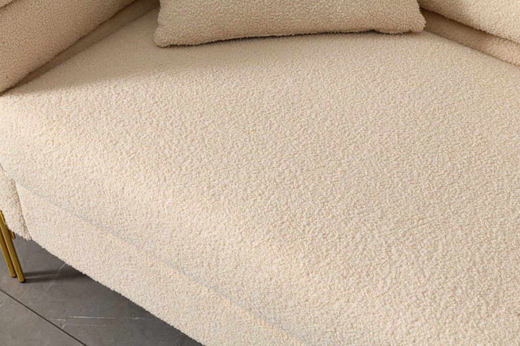 Luxurious and comfortable upholstered sofa with golden legs and pillows for living room and reception area