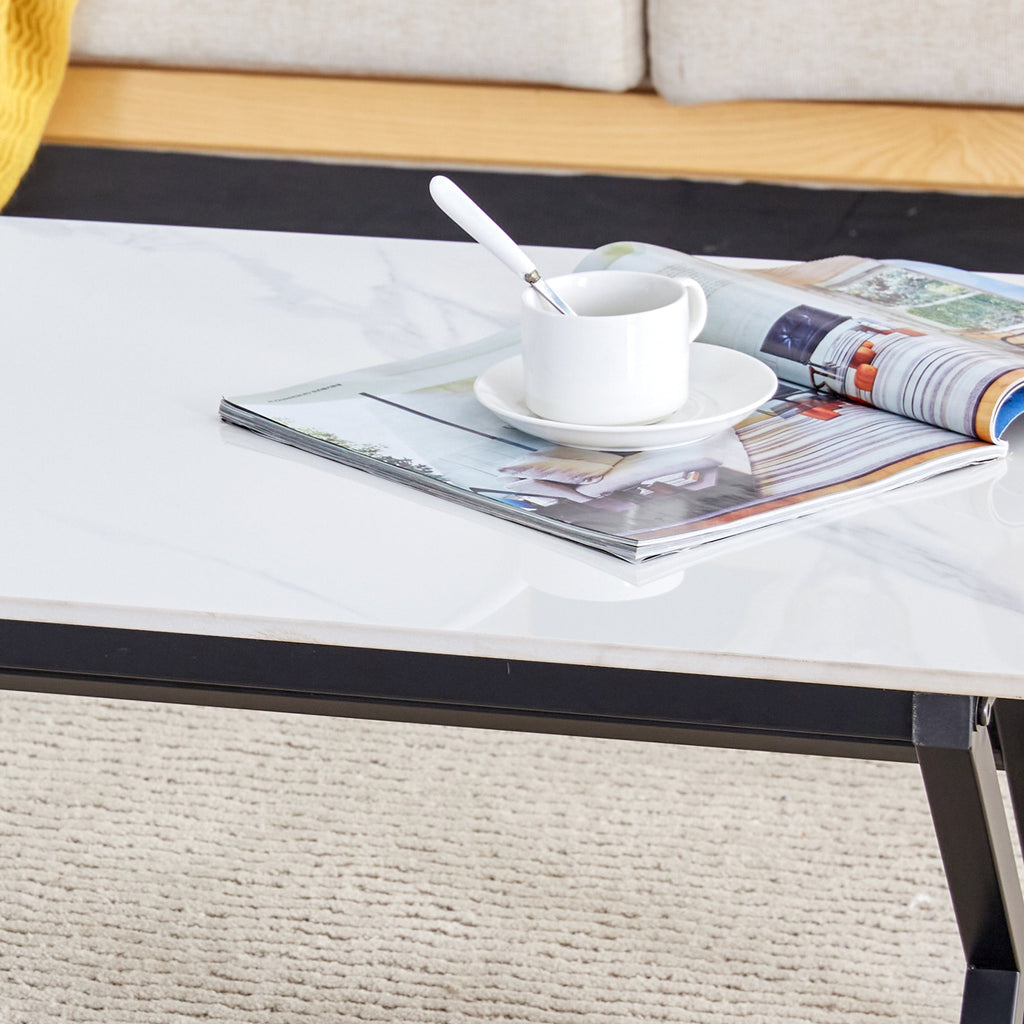 A coffee table made of rock slab material, with a smooth and natural surface that complements the modern design of the black metal legs, making it suitable for living rooms of all sizes.47*23.6