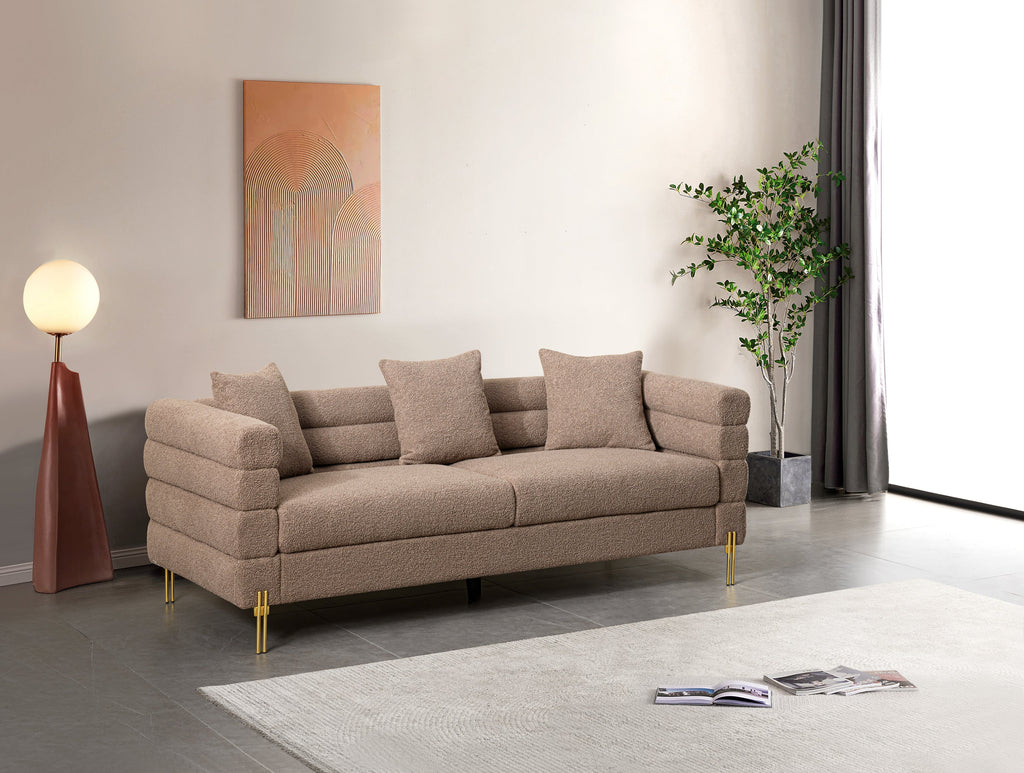 Luxurious and comfortable upholstered sofa with golden legs and pillows for living room and reception area