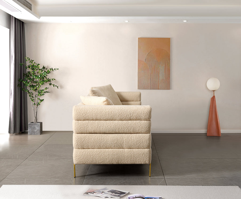 Luxurious and comfortable upholstered sofa with golden legs and pillows for living room and reception area