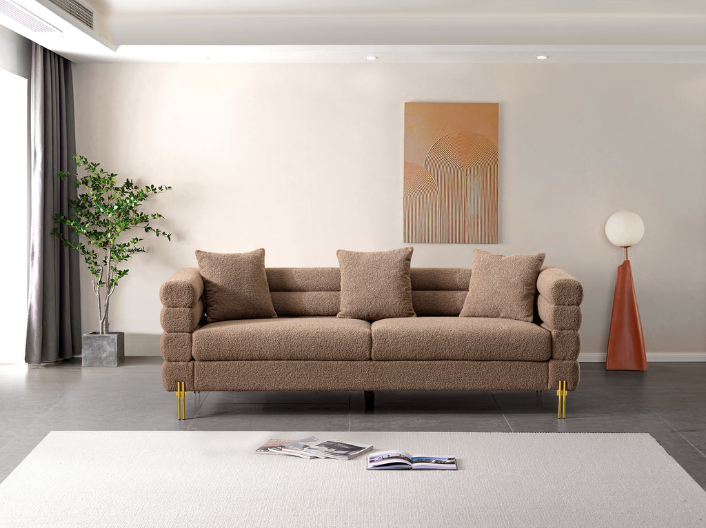 Luxurious and comfortable upholstered sofa with golden legs and pillows for living room and reception area
