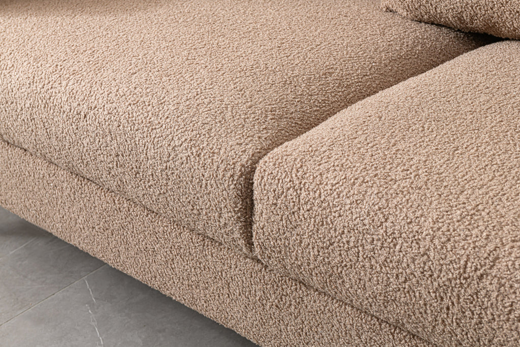 Luxurious and comfortable upholstered sofa with golden legs and pillows for living room and reception area