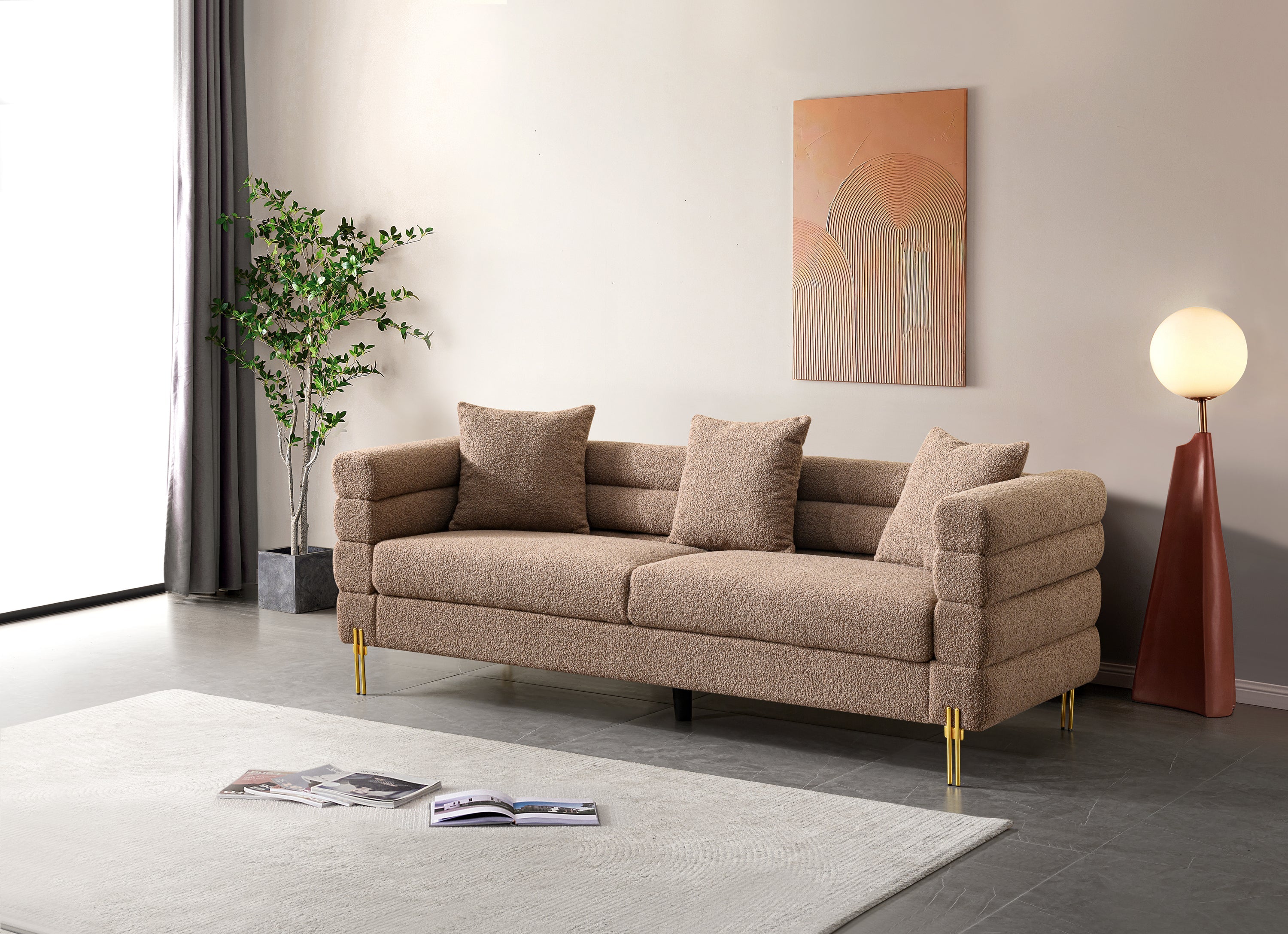 Luxurious and comfortable upholstered sofa with golden legs and pillows for living room and reception area