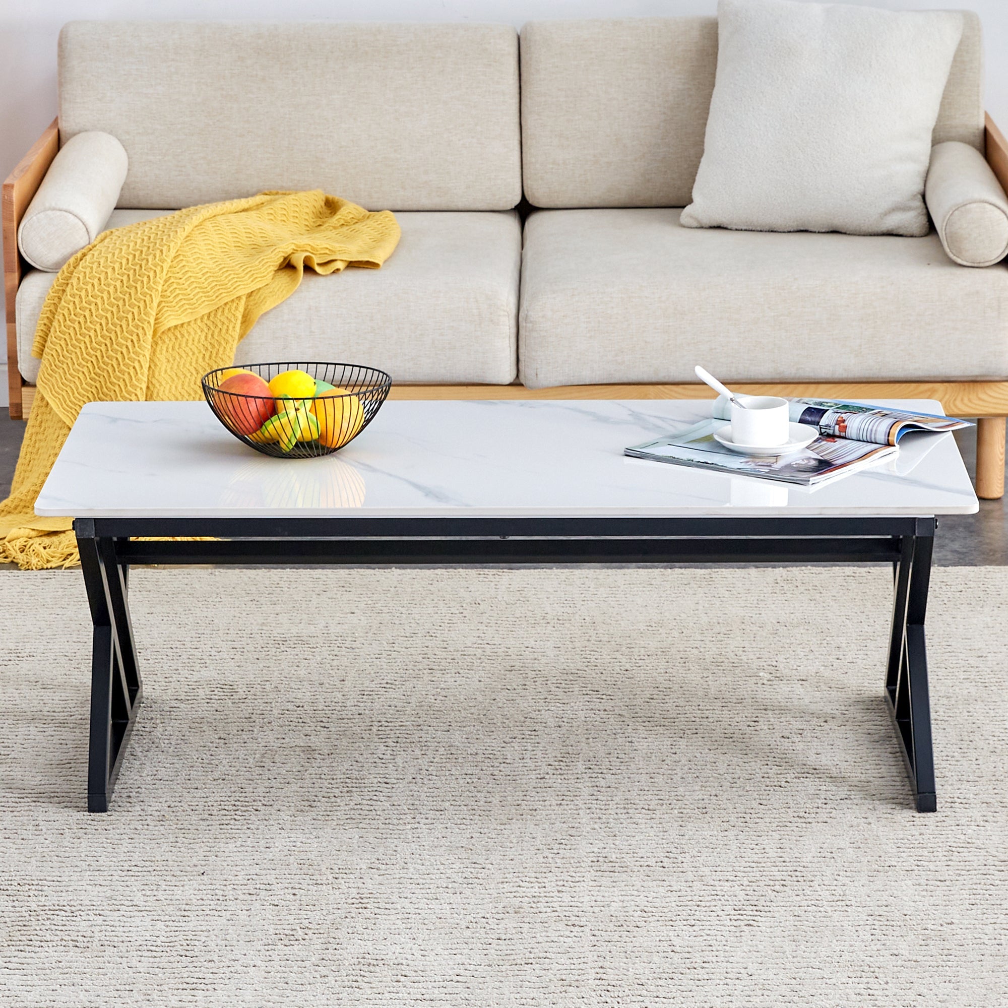 A coffee table made of rock slab material, with a smooth and natural surface that complements the modern design of the black metal legs, making it suitable for living rooms of all sizes.47*23.6